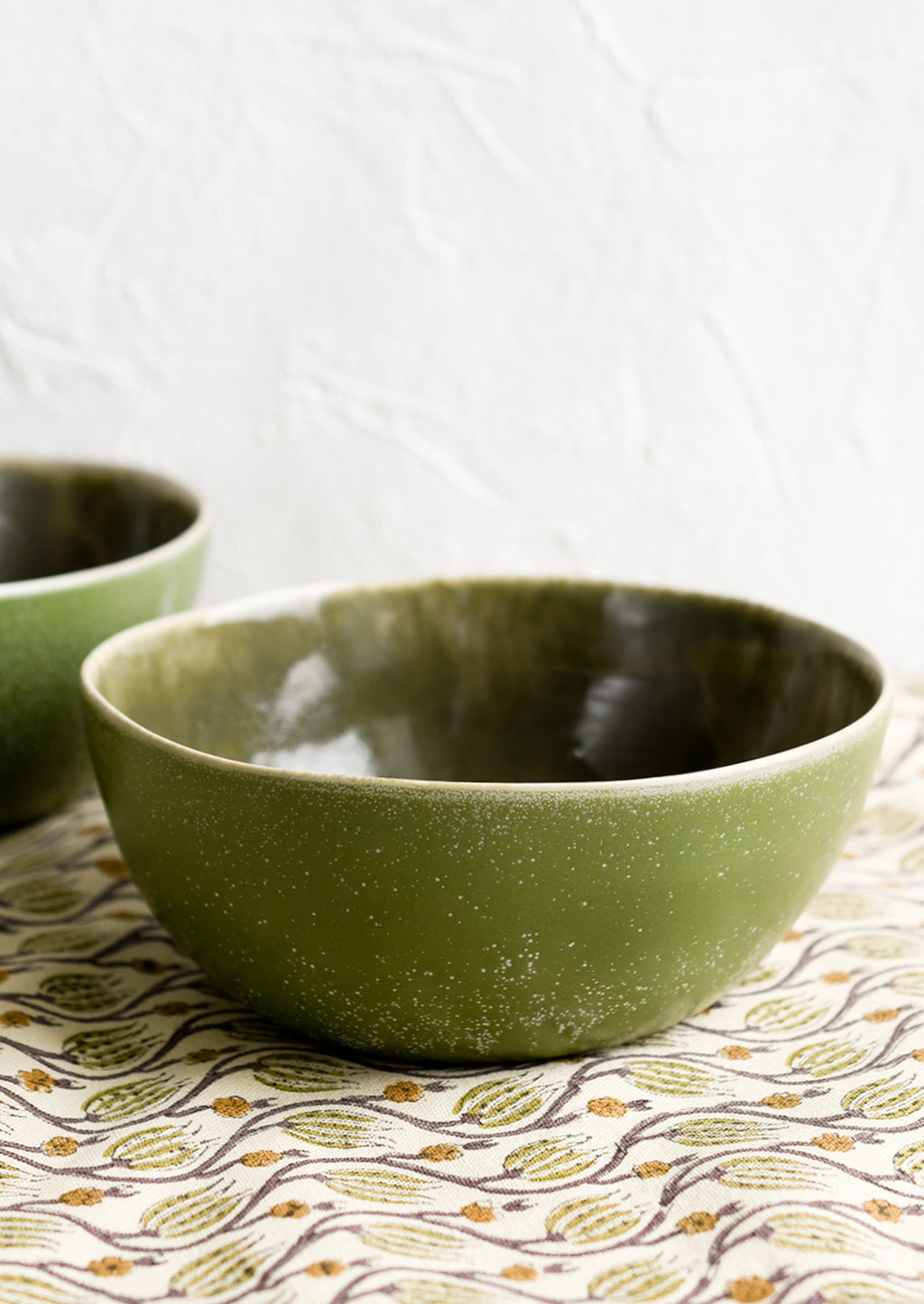 2: An olive green ceramic bowl.
