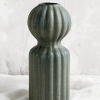 1: A curvy ceramic vase in teal glaze with ball-shaped top.