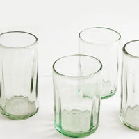 2: Four horizontally ribbed tumblers in thick green hued glass.