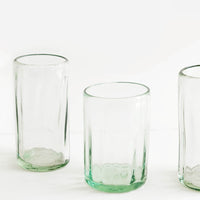 1: Three horizontally ribbed tumblers in thick green hued glass.