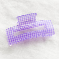 Lavender: A gingham print hair claw in purple.