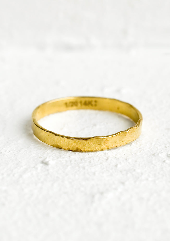 1: A thick width gold stacking ring with hammered texture.