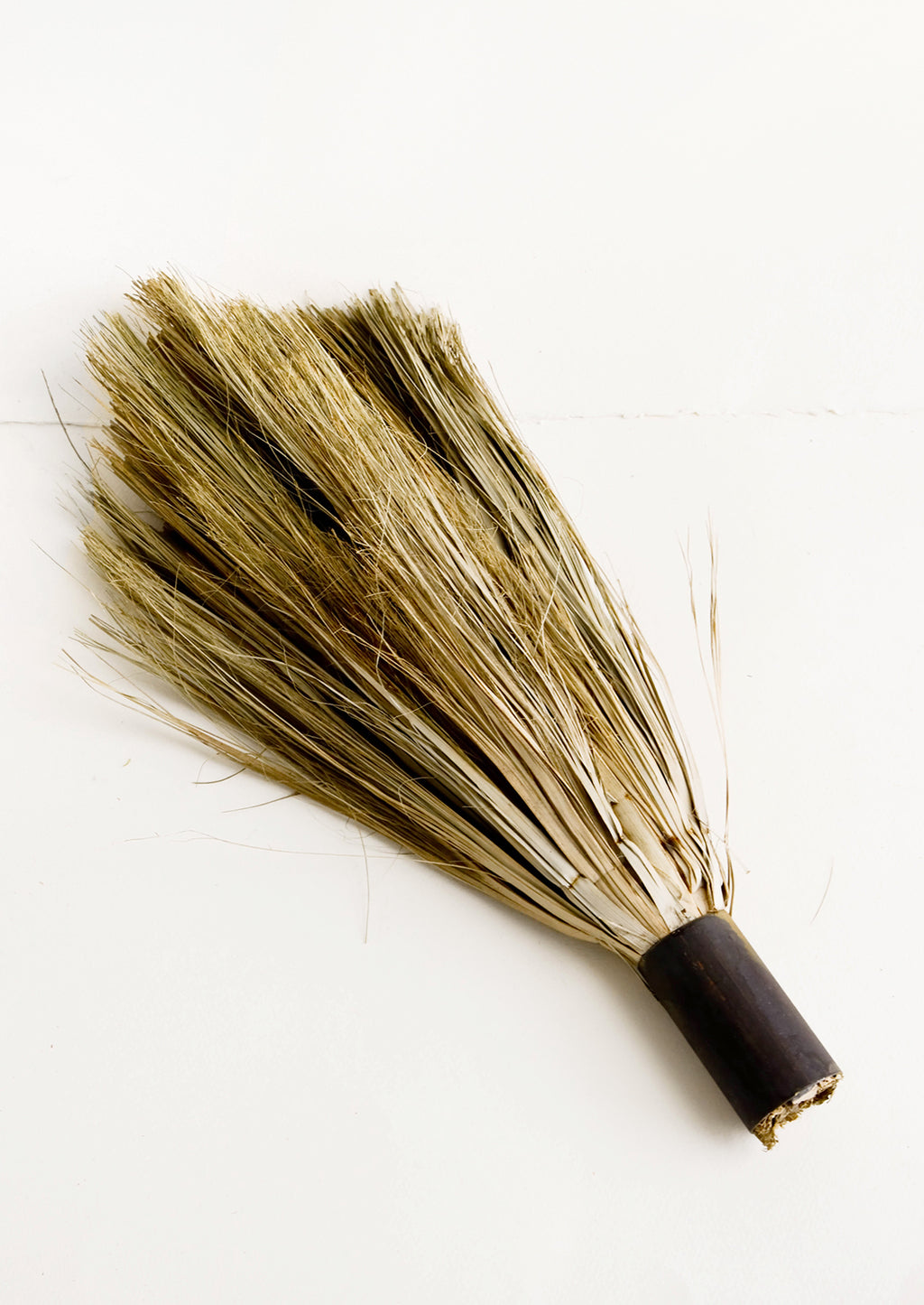 2: Primitive style handheld broom with cylindrical metal handle