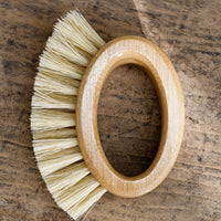 1: An oval shaped, open-handled scrubbing brush.