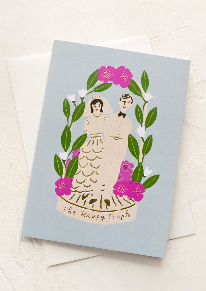 1: A blue greeting card with bride and groom, text reads "The happy couple".