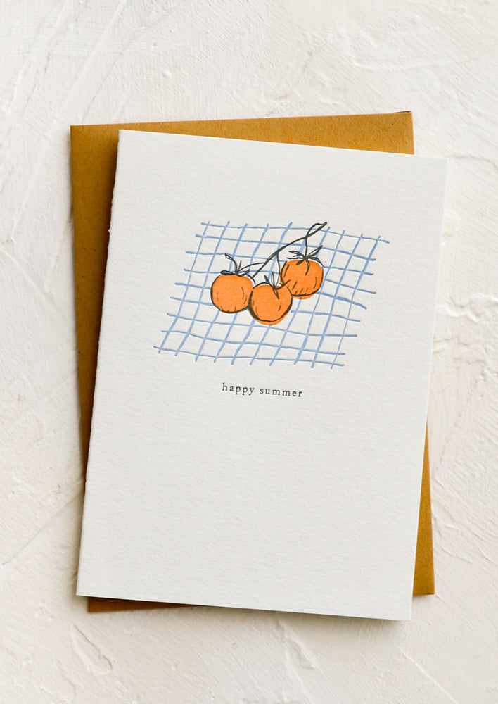 A greeting card with oranges on a picnic blanket, text reads "Happy summer".