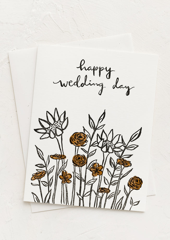 1: A greeting card with floral print reading "Happy wedding day".