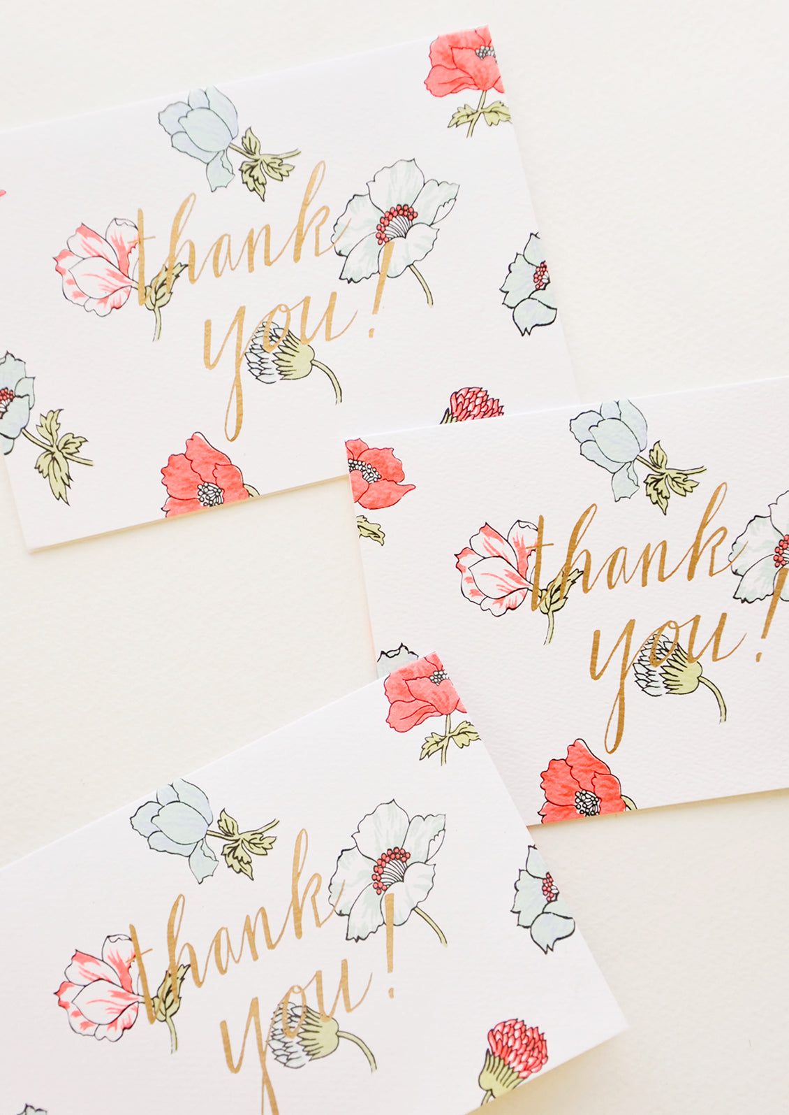 Set of notecards with neon flowers and the text "Thank you!" in gold foil.