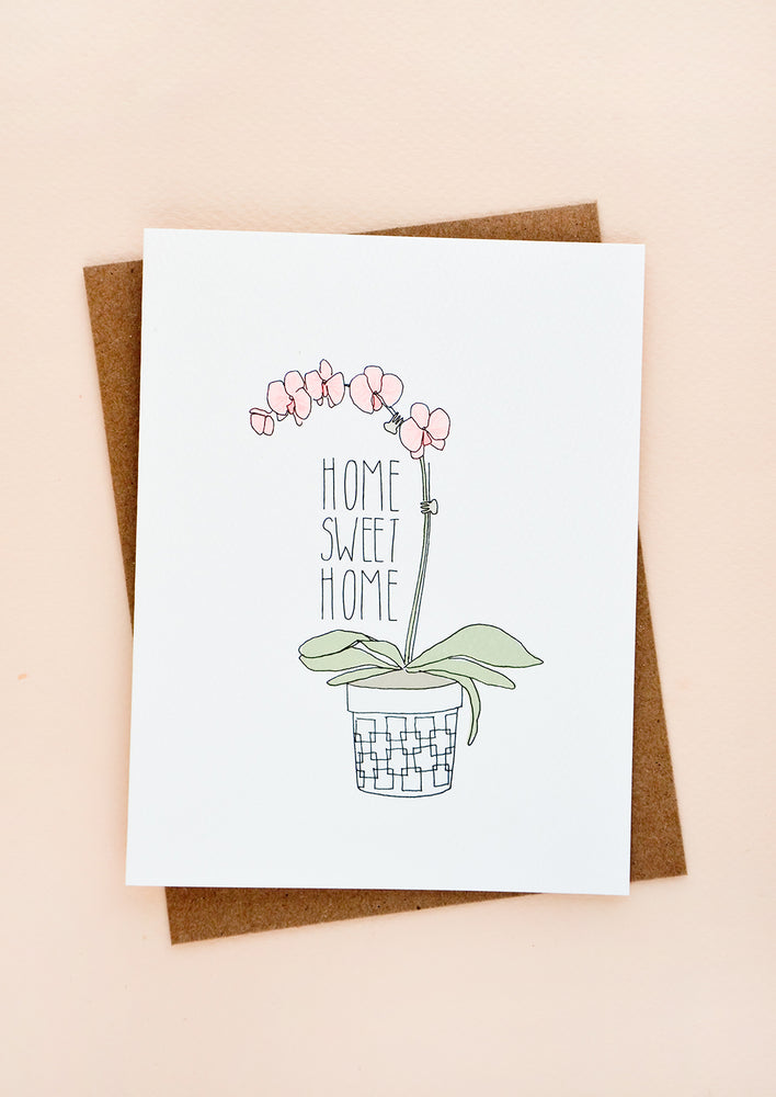 1: Greeting card with image of potted orchid and text reading "Home Sweet Home"