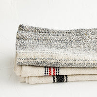2: Stack of thick woven cotton towels in assortment of natural, blue and red colors