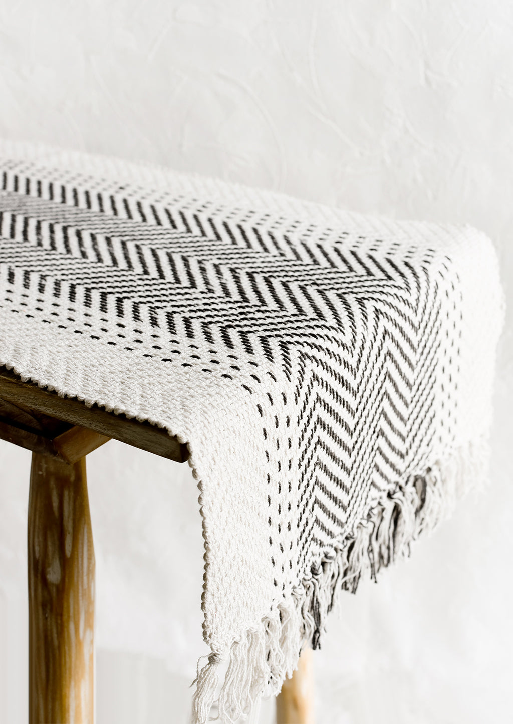 2: A cream textured cotton table runner with herringbone stitch down middle.