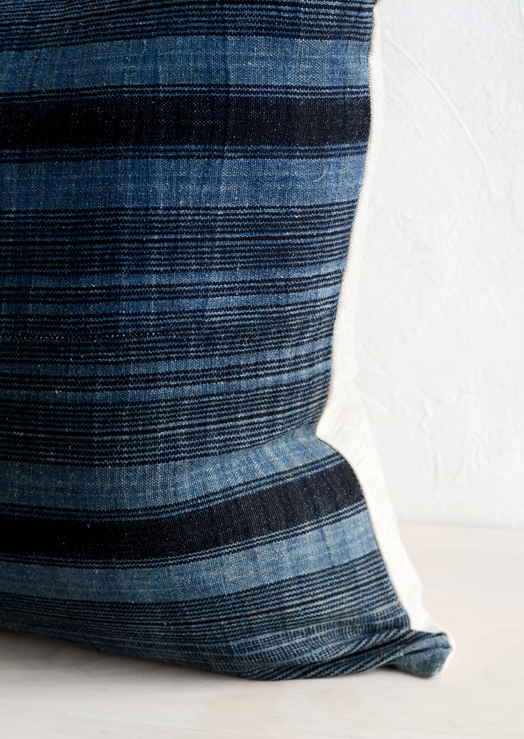 3: Indigo fabric with variegated black stripes.
