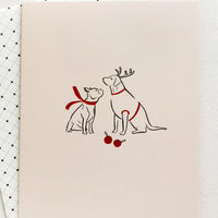 2: A card with illustration of two dogs wearing red scarves.