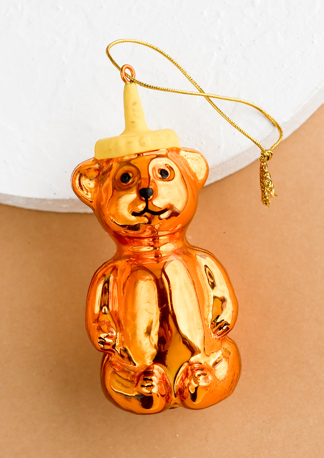 A decorative holiday ornament in shape of honey bear.
