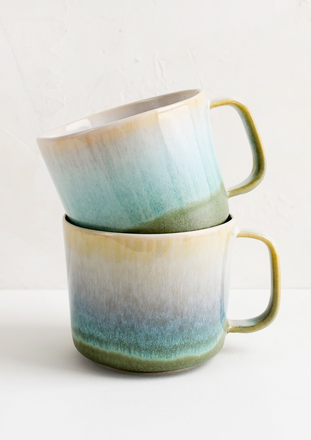 5: Two stacked ceramic mugs.