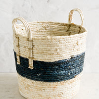 1: A storage basket with two top handles, woven from natural fiber.