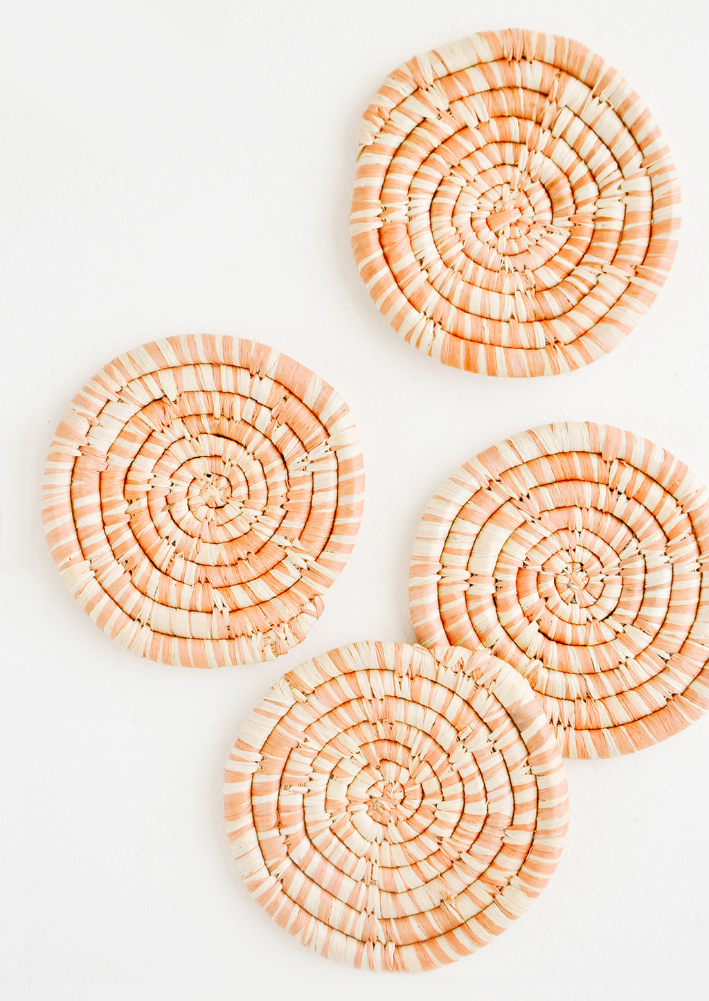 Peach: Set of 4 Round Woven Raffia Coasters in Peach and natural stripe.