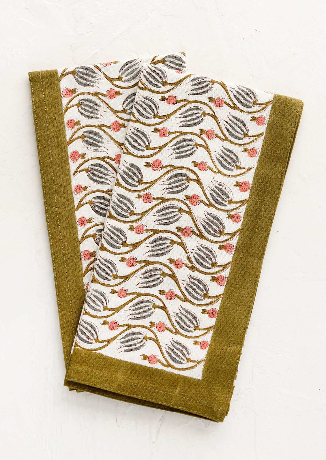 Floral print napkins with khaki green border.