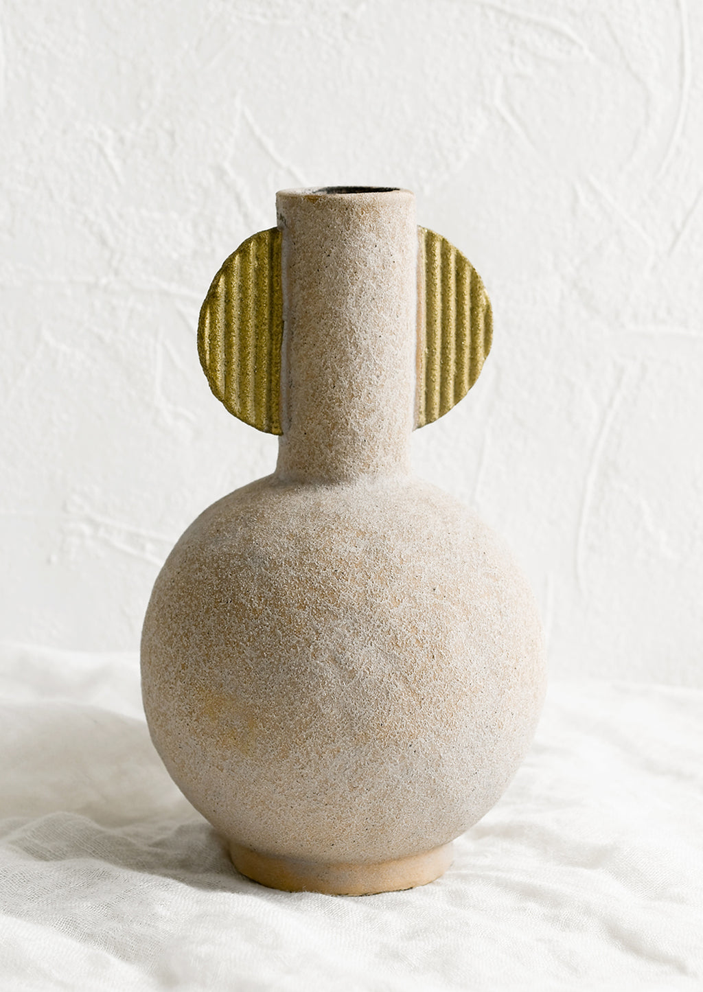 1: A sculptural ceramic vase with narrow neck opening.