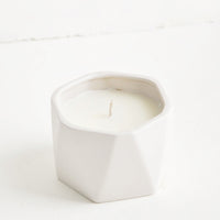 Gardenia: A small candle in white faceted ceramic vessel.