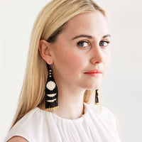 2: Model shot showing woman wearing beaded earrings and white top.