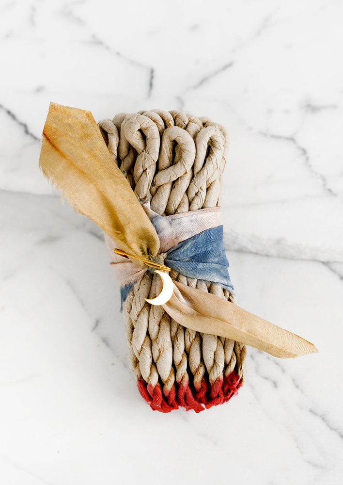 1: A silk ribbon bound bundle of incense rope.