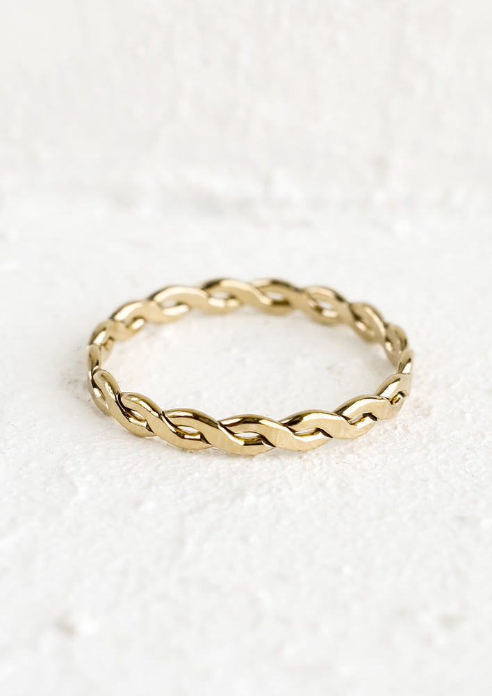 1: A gold ring with braided silhouette.