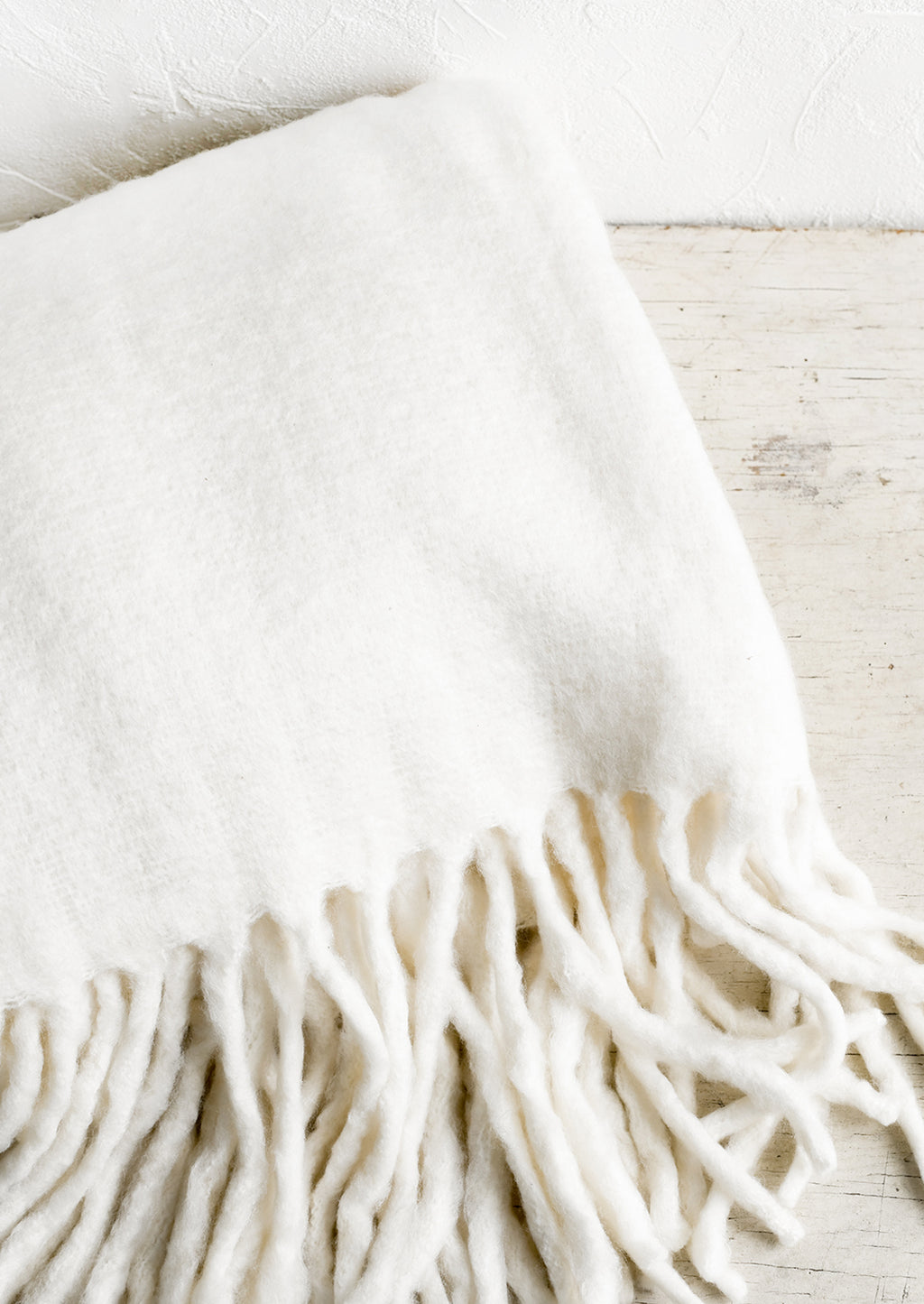 Ecru: A fuzzy ivory blanket with fringe.