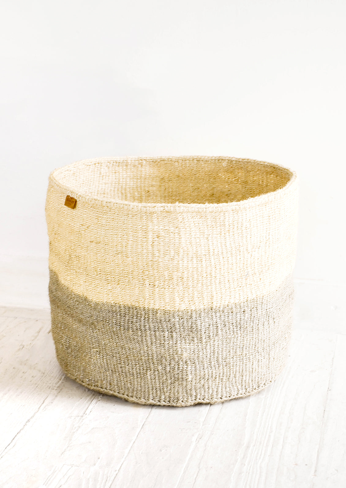 Round storage basket made from sisal, natural with dip dye gray bottom