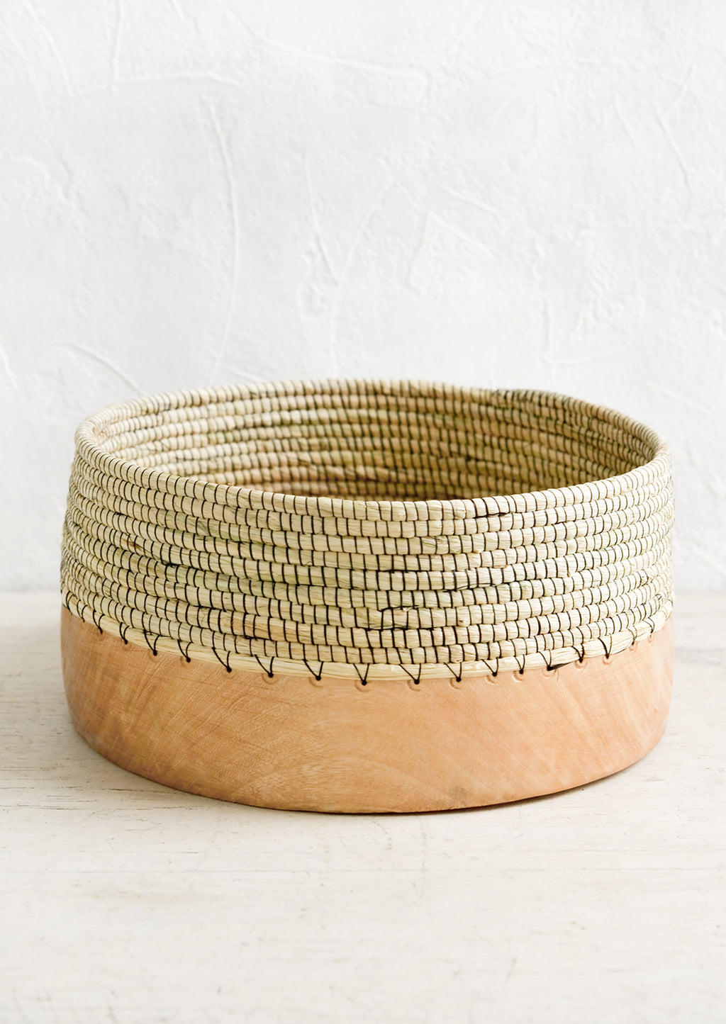 Large: A wide, shallow bowl made from half wood and half woven grass with black thread.
