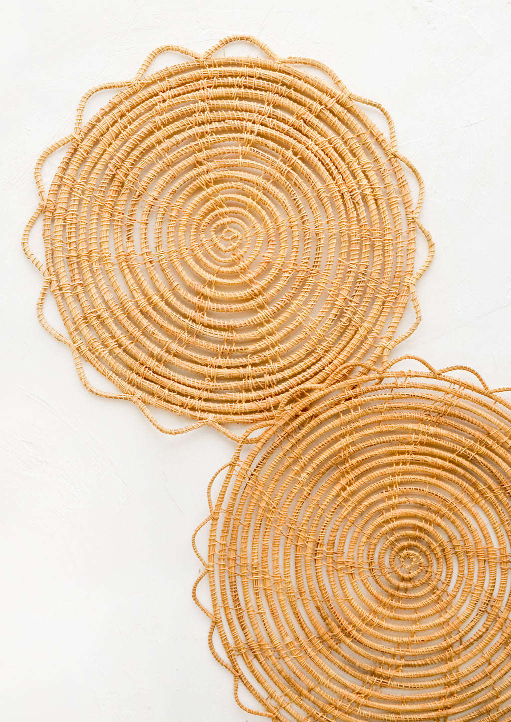3: A round placemat set with open weave scalloped edge.