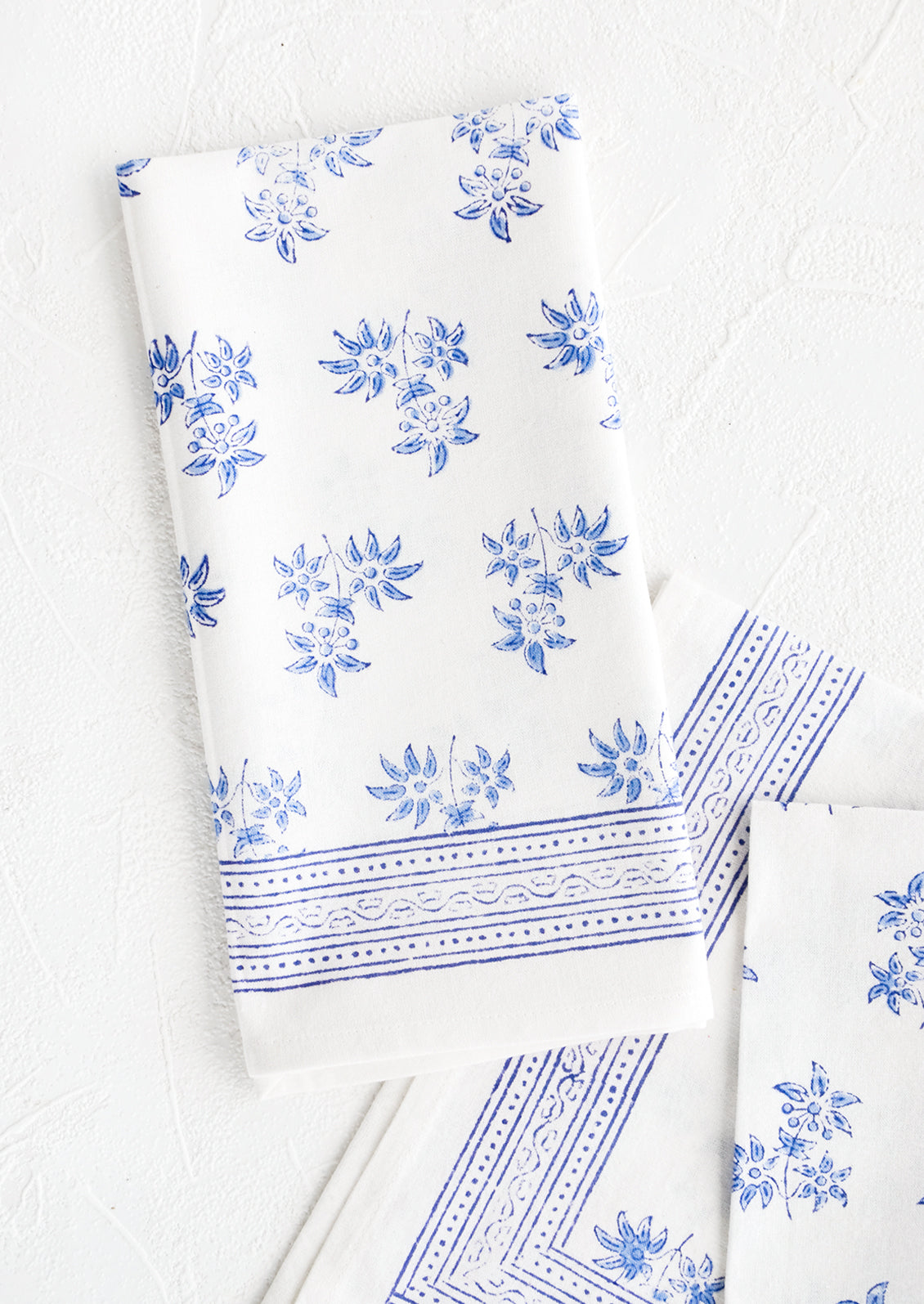 Pair of block printed cotton dinner napkins with blue floral pattern