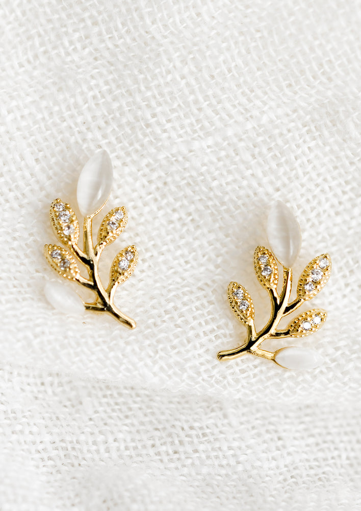 1: A pair of gold leaf shaped studs with crystal and gemstone "leaves".