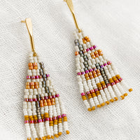 Bone Multi: A pair of beaded earrings in neutral and magenta colorway.