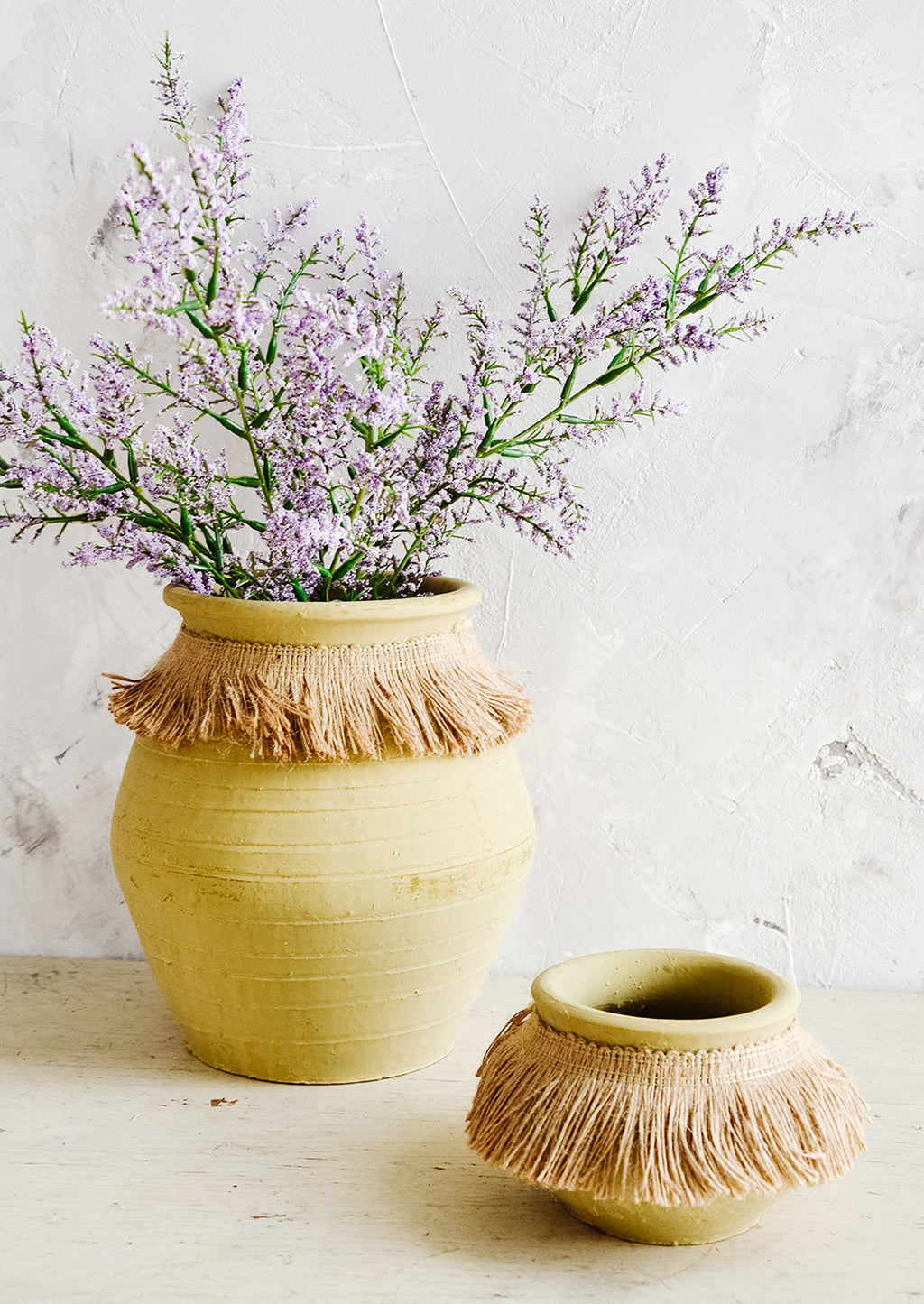 5: Clay pots with jute trim around neck, one displaying purple flowers