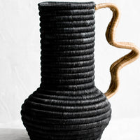 Black / Tan: A sculptural sweetgrass vase with wavy handle in black with tan.