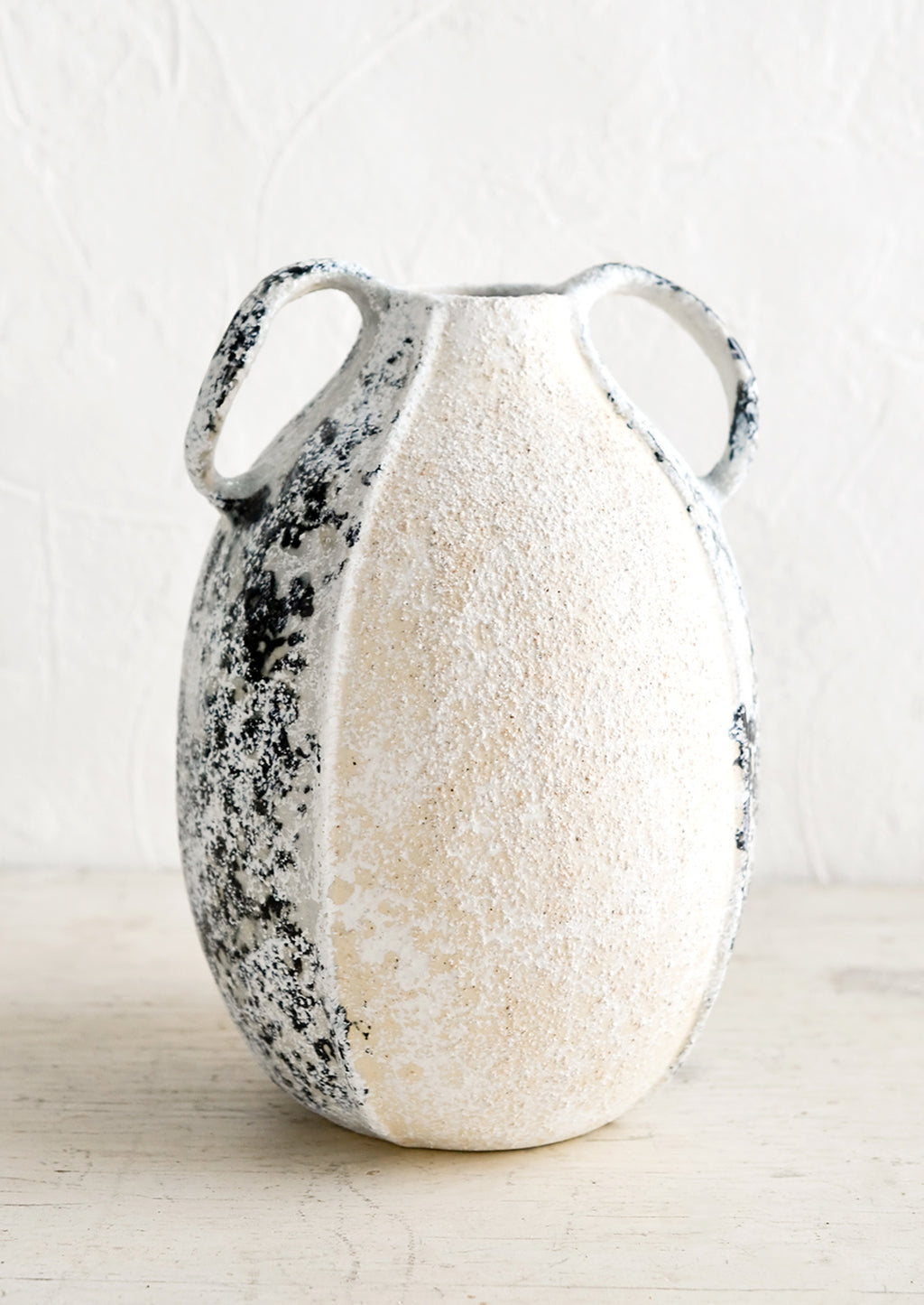 Large: A distressed ceramic vase in tall shape with side handles.