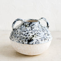 Small: A distressed ceramic vase in short shape with side handles.