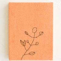 Peach: A peach cloth covered journal with botanical embroidery detail.