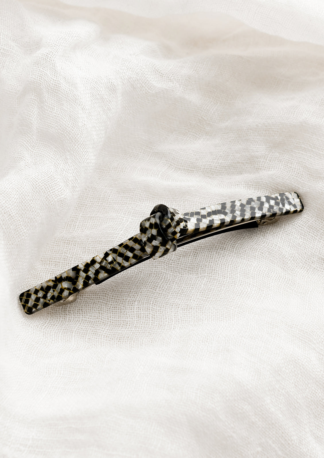Acetate barrette with knot detail in black and white checker