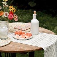2: An outdoor table setting with grapefruit and flowers.