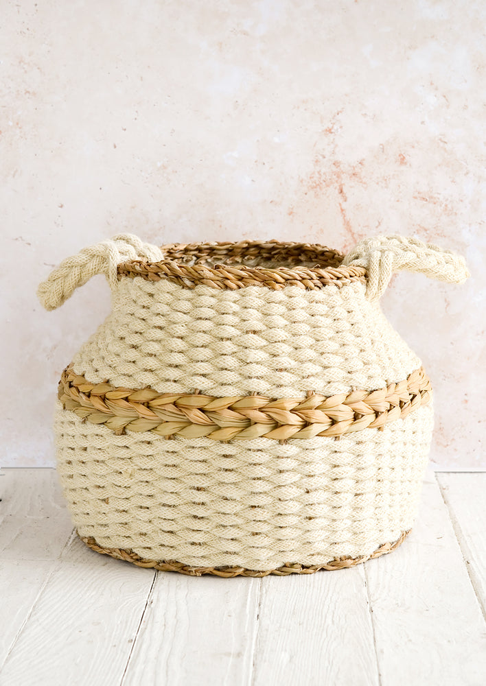 1: A round and wide, squat basket woven from jute rope and seagrass.