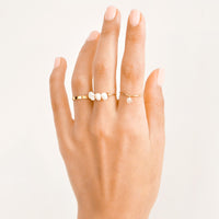2: Hand modeling assorted gold and pearl rings