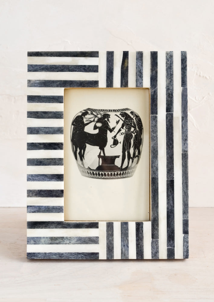 1: A bone picture frame with charcoal and ivory lined border.