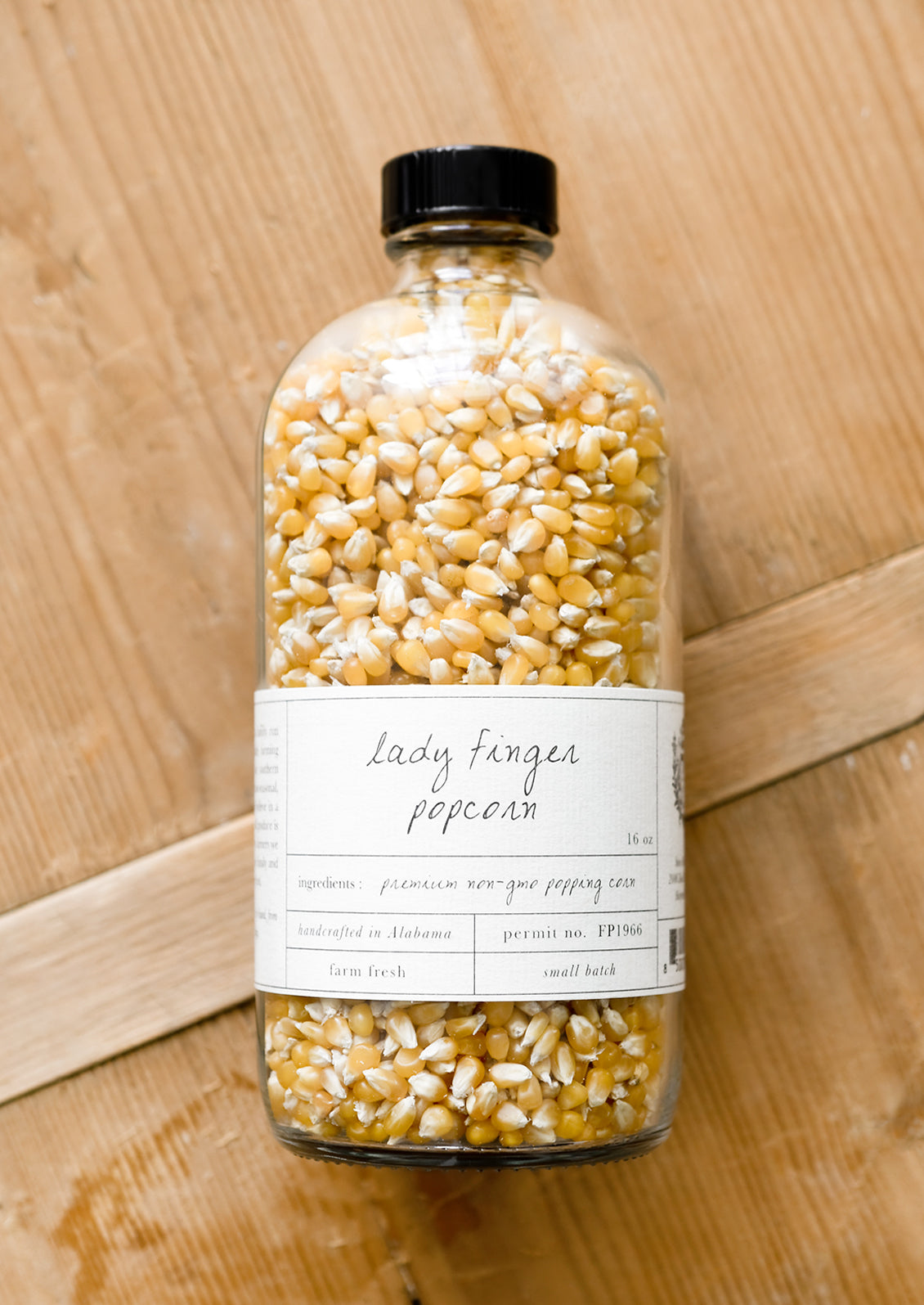 A glass bottle of small kernel popcorn.