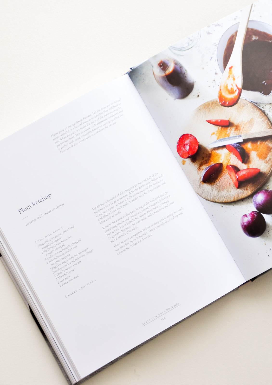 A cookbook opened to a recipe for plum ketchup.