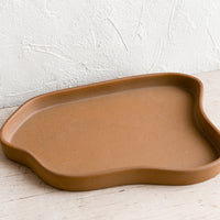 Large / Brown: An asymmetrical large ceramic tray in matte brown.