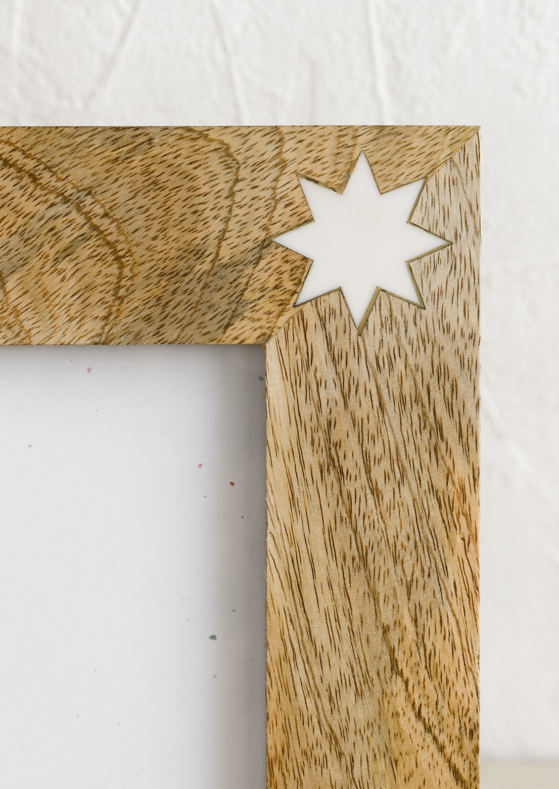 White resin star detailing on wood.