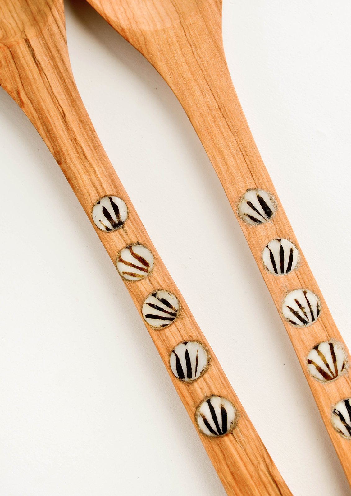 Detail of round, patterned bone inlay on spoon handles