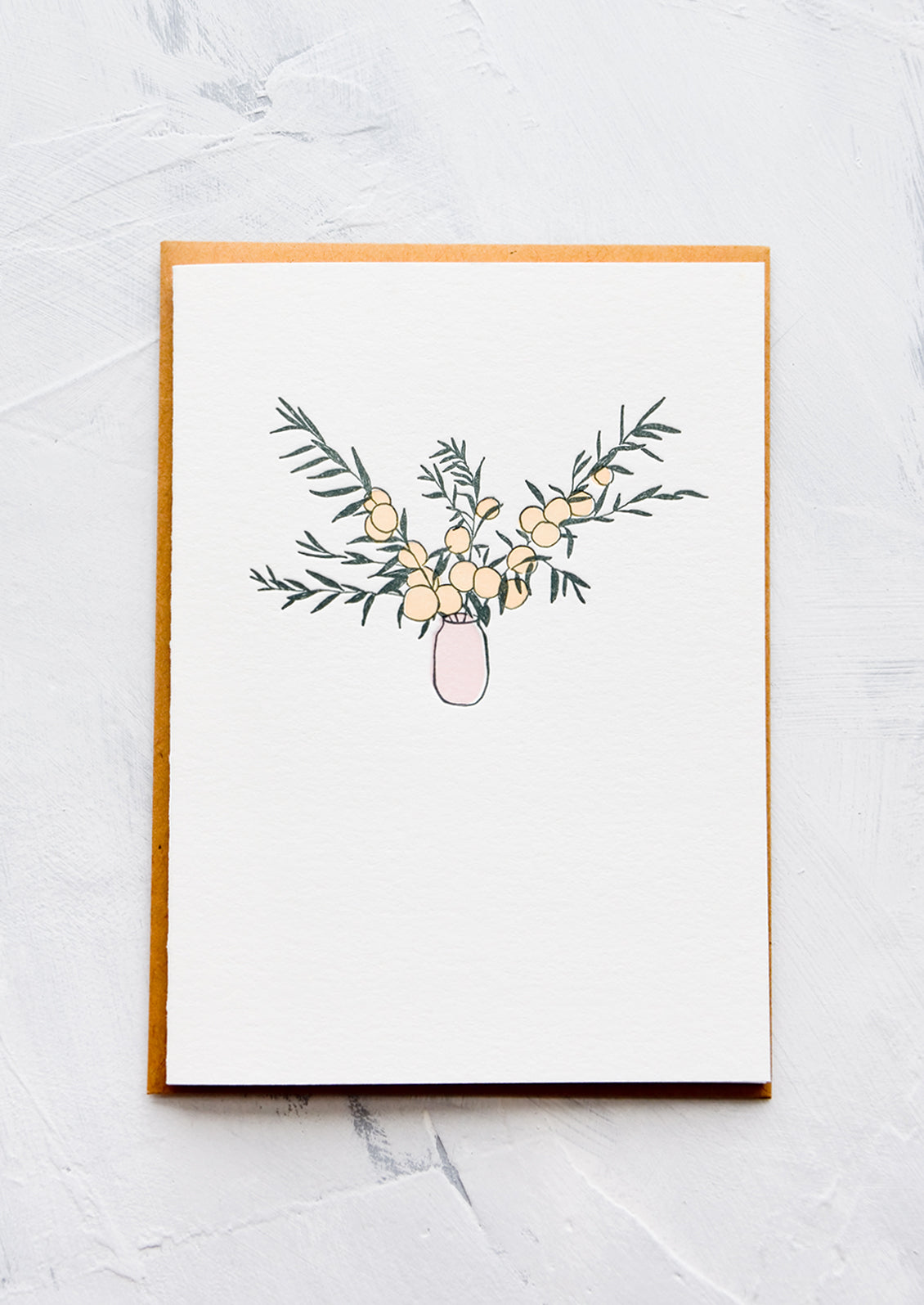 A letterpress printed greeting card with an image of citrus branches in a pink vase